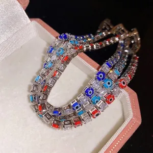 Sparkling silver-toned zircon bracelets with colorful evil eye charms in a pink jewelry box
