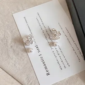 Elegant butterfly stud earrings with pearls and minimalist silver-needle design