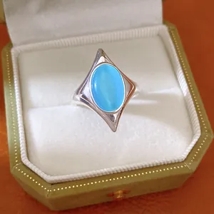 Close-up of blue cat's eye stone on star shaped silver adjustable ring in gift box