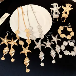 Vintage gold and silver metallic seashell jewelry set featuring starfish and conch designs
