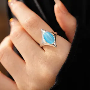 Close-up of a vintage blue cat's eye stone set in a silver starburst adjustable ring