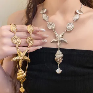 Detail showing vintage gold and silver metallic necklaces with starfish and shell elements