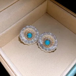Detail of vintage silver floral earrings with turquoise center and zircon accents in box.
