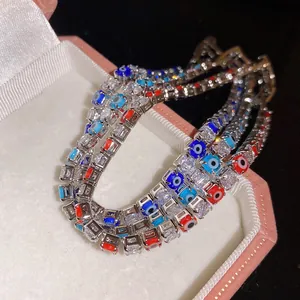 Close-up detail of luxury zircon tennis bracelet featuring vibrant colorful evil eye charms