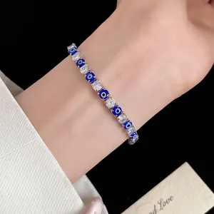 Close-up of elegant evil eye zircon bracelet with blue beads and shiny crystals for women