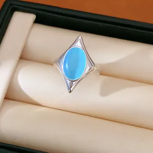 Detailed close-up of a blue cat's eye stone oval star open ring in a jewelry box.