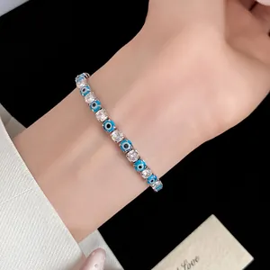 Detailed view of an elegant evil eye bracelet with clear zircons on a lady's wrist