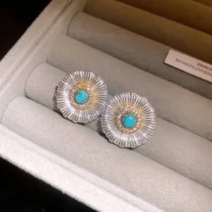 Detailed view of vintage silver stud earrings with turquoise and zircon accents