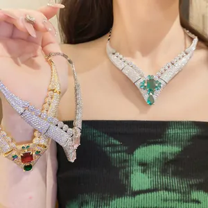 Detail of vintage 18k gold plated zircon necklaces in emerald styles worn by model