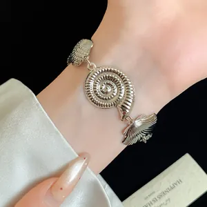 Vintage silver-finish metallic seashell bracelet with elegant wrinkled texture.