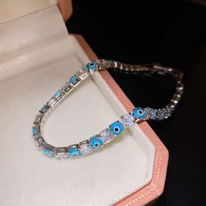 Macro detail of elegant evil eye bracelet with clear zircons in a pink jewelry box
