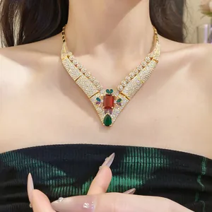 Detail shot of a vintage royal style 18k gold plated necklace featuring a large red zircon