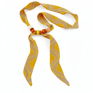 Bohemian mustard yellow ribbon necklace with wood beads and wave embroidery detail