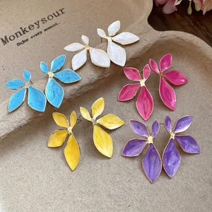 Vintage enamel flower stud earrings in multiple vibrant colors presented on display tray.