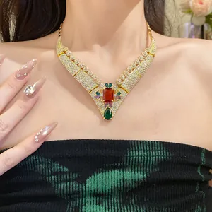 Detailed view of a vintage palace style 18k gold plated necklace with colorful zircons.