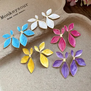 Macro detail showing the glossy enamel texture of these colorful flower stud earrings.