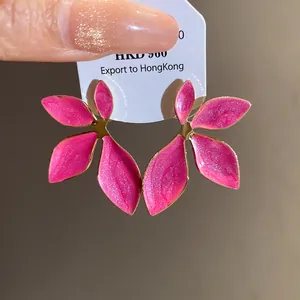 Vibrant pink enamel flower stud earrings featuring elegant gold-plated edges and vintage design.