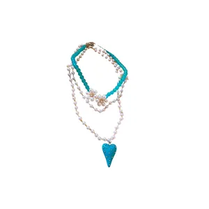 Double-layered pearl necklace with turquoise beads, flower motifs, and heart pendant
