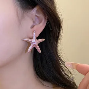 Large iridescent pink starfish stud earring for a vintage beach vacation inspired look