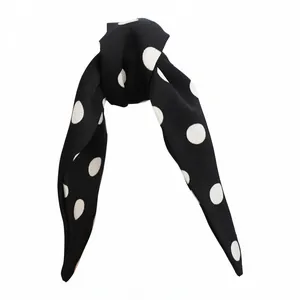Elegant classic black and white polka dot bow hair clip for stylish ponytail hairstyles.
