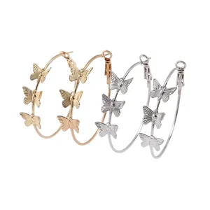 Two pairs of large butterfly hoop earrings in gold and silver metallic finishes