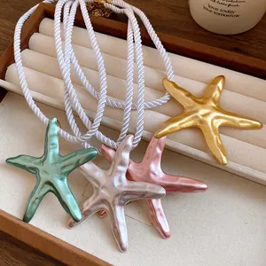 Detail view of colorful metallic starfish pendants on high-quality twisted white silk cord necklaces