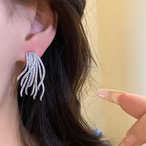 Detail view of vintage sparkling zircon dangling earrings with high-end gold plated finish
