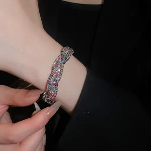 Elegante Detailaufnahme eines geflochtenen Vintage-Armbands mit bunten Strasssteinen