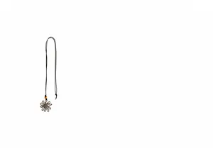 Detailed view of a long necklace featuring a large hollow flower pendant on a black cord