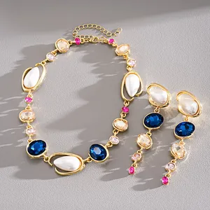 Detail of vintage pearl necklace set with teardrop crystals in gold finish.