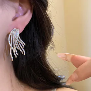 Close-up detail of luxurious 18k gold plated zircon earrings worn on a model