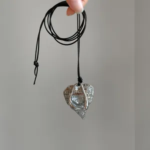 Vintage silver-tone wrinkled heart pendant necklace on a minimalist adjustable black cord