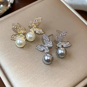 18K gold plated butterfly stud earrings with sparkling crystals and elegant pearls.