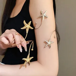 Elegant gold and silver starfish open arm bracelets for women with a textured finish.