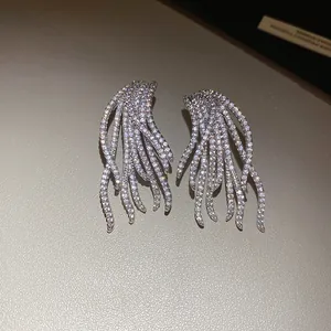 Macro view of 18k gold plated zircon stud earrings with a sparkling feather design