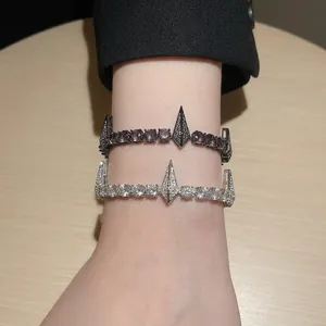 Trendy hip hop punk style zircon bracelets in silver and black metal finishes on wrist