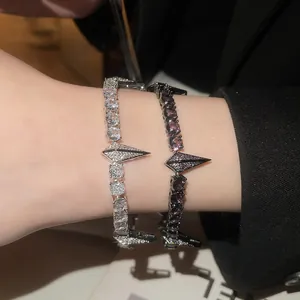 Close-up of zircon punk bracelets in silver and black with geometric spike detail