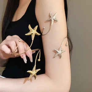 Detailed view of stylish metallic pleated starfish open arm cuff bracelet worn on arm