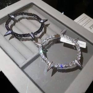 Close-up of spiked panther-style bracelets with sparkling zircons in a jewelry box.