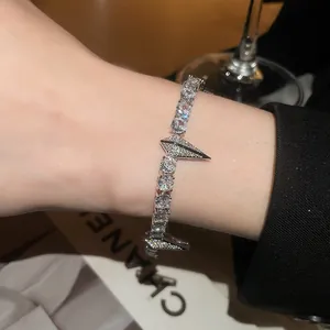 Exquisite sparkling zircon punk style bracelet with pointed arrowhead elements worn on wrist