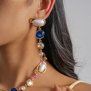 Detailed view of luxury vintage teardrop pearl and colorful crystal jewelry set on model