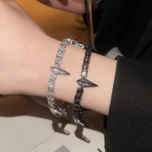 Close-up of shimmering zircon panther head bracelets in silver and black punk style finishes