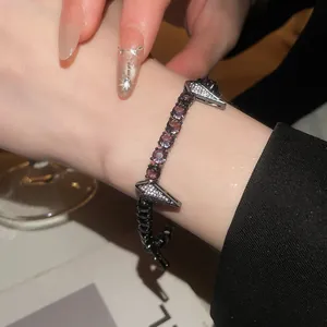 Detailed close-up showing the sparkling zircon-encrusted panther buckle of this punk bracelet
