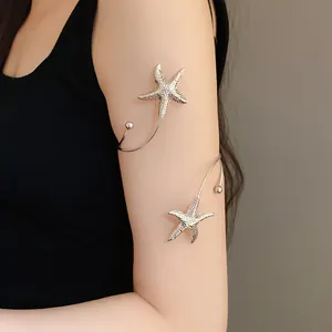 Close-up of a silver metal starfish open arm bangle with a wrinkled texture on an arm