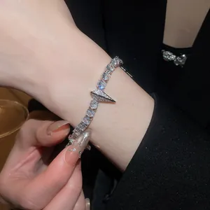 Close-up of sparkling cubic zirconia punk bracelet with geometric spike charm on wrist