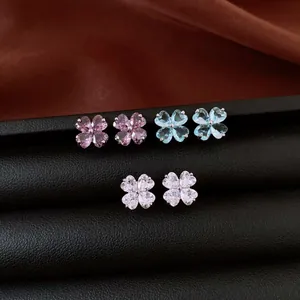 Detailed macro view of pastel heart-shaped zircon flower stud earrings on display