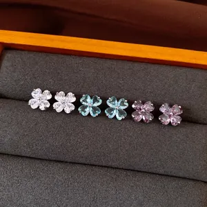 Detailed view of elegant zircon flower stud earrings in white, blue, and purple hues