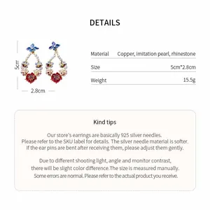 Detailed view of floral earrings with rhinestones and imitation pearls specifications