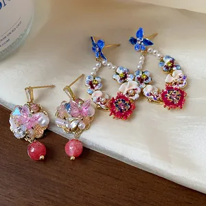 Macro view of 14K gold plated floral earrings with colorful crystals and pearls