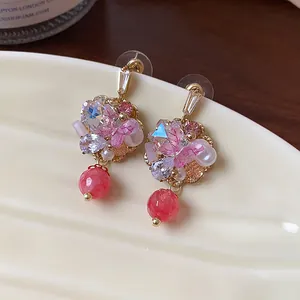Detailed view of exquisite 14K gold plated flower earrings with pink butterfly and crystal